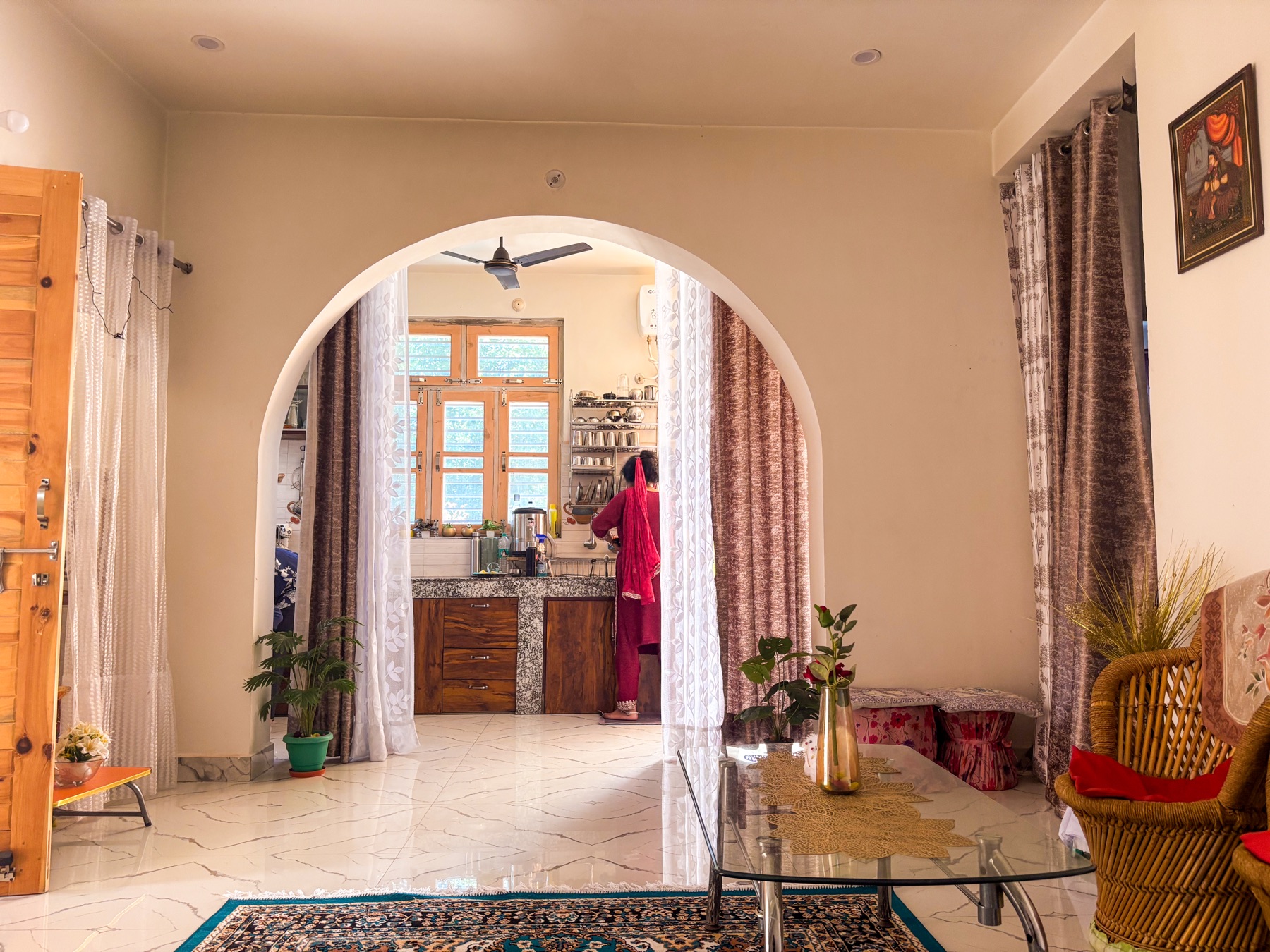 The kitchen seen through an archway from the living room