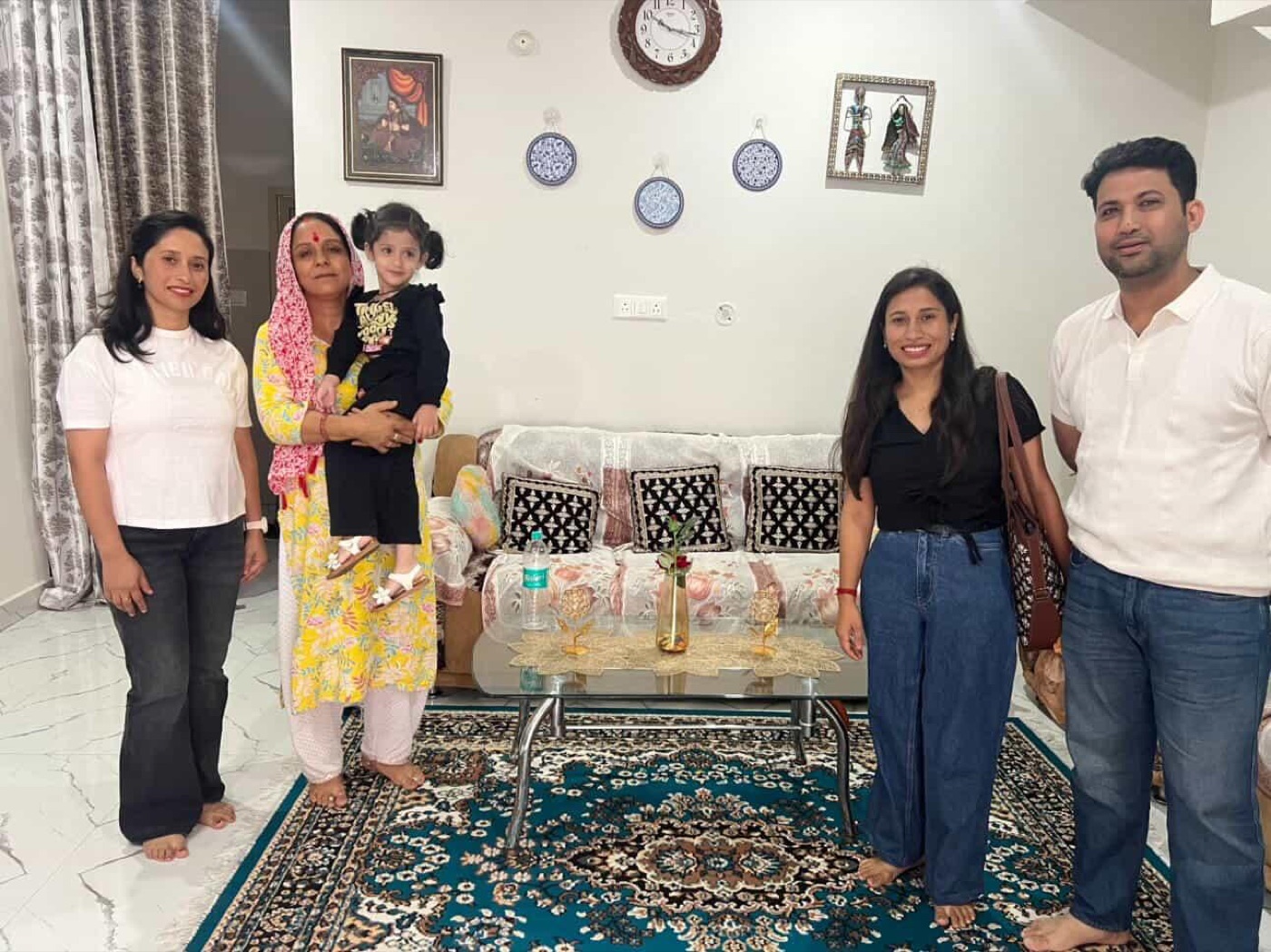 A family with Bimla aunty in the dera living room