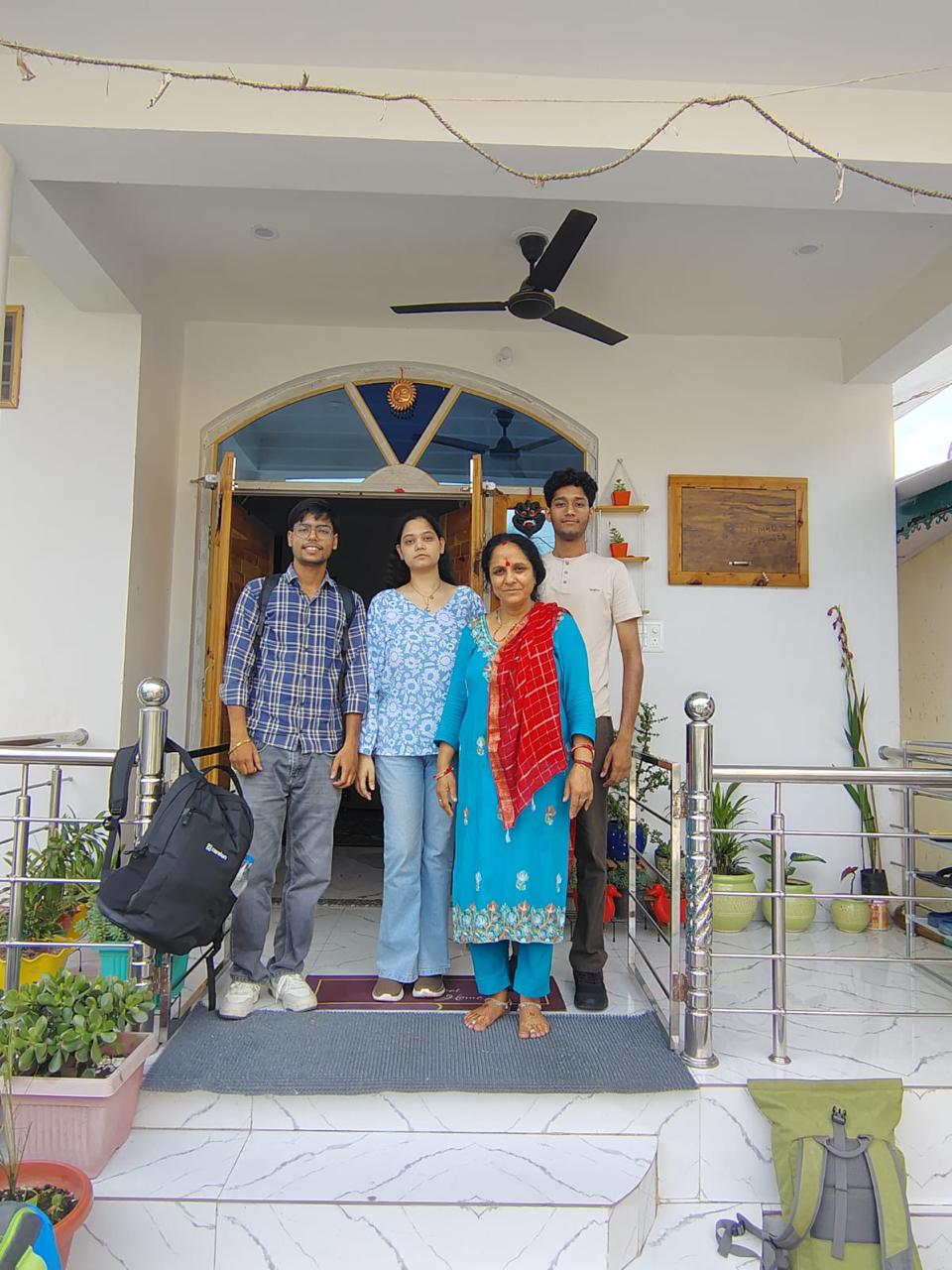 A family of three with Bimla aunty at the dera entrance